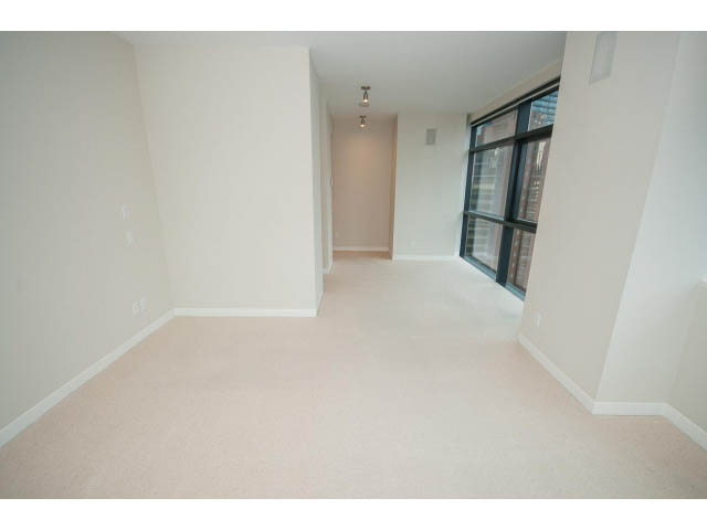 Bright living room with large window and carpeted floors. - 1902 - 838 W Hastings, Vancouver Downtown