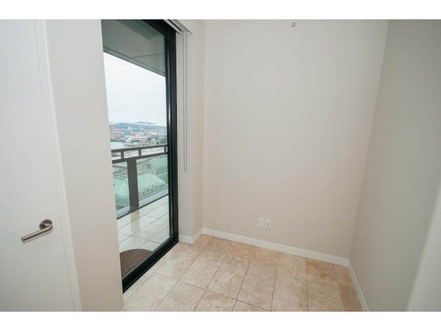 Bright living room with tiled floor and city view through sliding glass door. - 1902 - 838 W Hastings, Vancouver Downtown