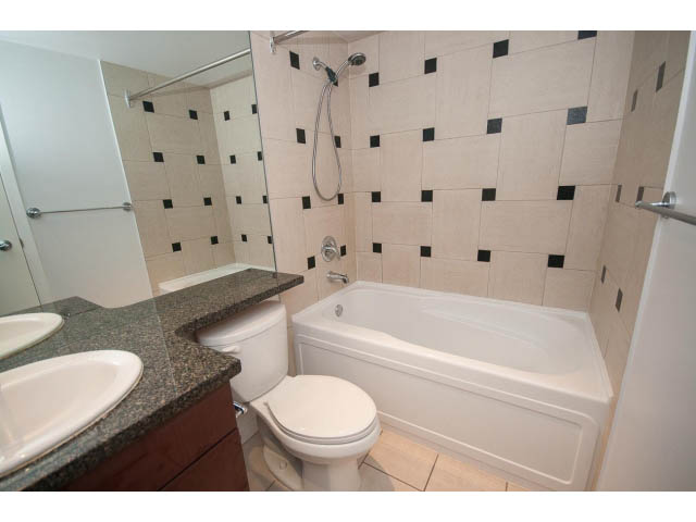 Furnished bathroom with granite countertops and a corner bathtub. - 2005 - 1067 Marinaside Crescen, Vancouver Downtown