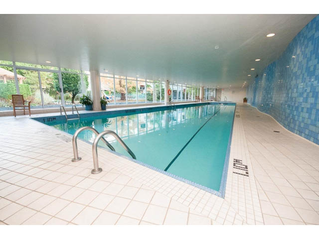 Spacious, well-lit indoor pool area with tiled floors and blue mosaic walls. - 2005 - 1067 Marinaside Crescen, Vancouver Downtown