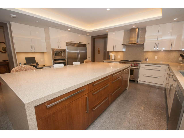 Bright kitchen with granite countertops and stainless steel appliances, modern design. - 5070 Marine Drive, West Vancouver