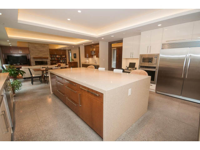 Modern kitchen with granite countertops and stainless steel appliances. - 5070 Marine Drive, West Vancouver