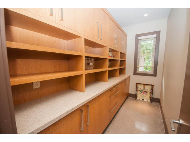 Spacious laundry room with wooden shelves and granite countertops. - 5070 Marine Drive, West Vancouver