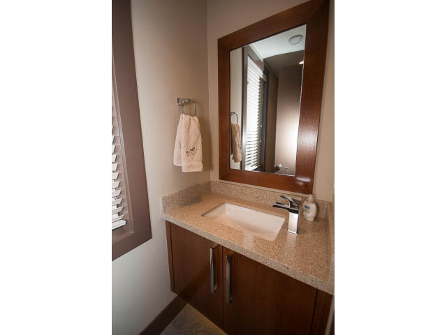 Bathroom with granite countertops and wooden cabinets. - 5070 Marine Drive, West Vancouver