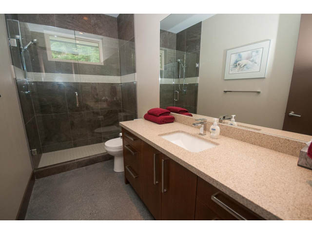 Spacious bathroom with granite countertops and modern shower. - 5070 Marine Drive, West Vancouver