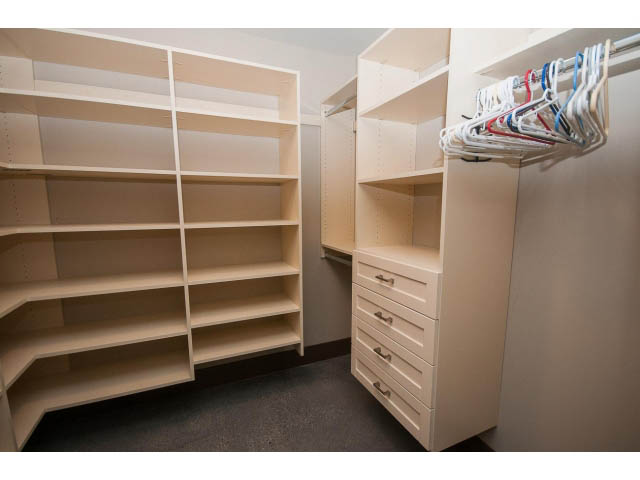 Walk-in closet with built-in shelves and hanging rod. - 5070 Marine Drive, West Vancouver