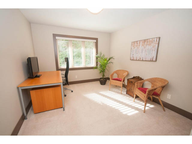 Bright and airy office space with a desk, chair, and window with blinds. - 5070 Marine Drive, West Vancouver