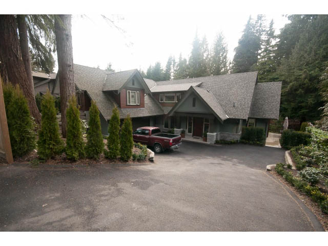 Spacious 4-bedroom house with large driveway and surrounding trees. - 5070 Marine Drive, West Vancouver
