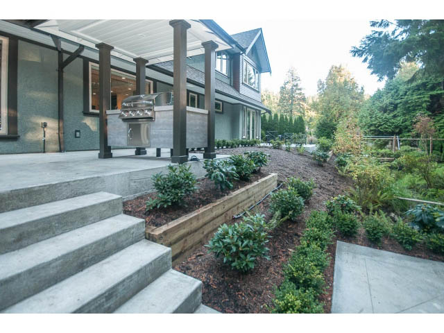 Furnished living room with stone steps and landscaped garden. - 5070 Marine Drive, West Vancouver