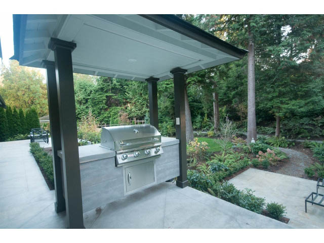 Covered patio with modern grill and outdoor seating area. - 5070 Marine Drive, West Vancouver
