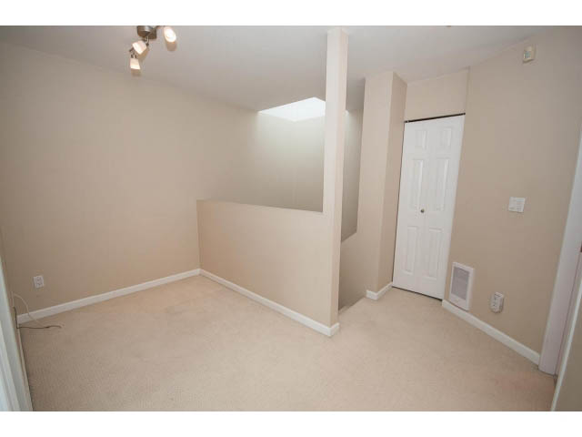 Living room with carpeted floors and white walls. - 1962 West 11th Ave, Vancouver West Side