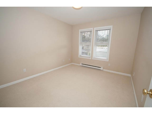 Spacious living room with carpeted floors and two windows. - 1962 West 11th Ave, Vancouver West Side