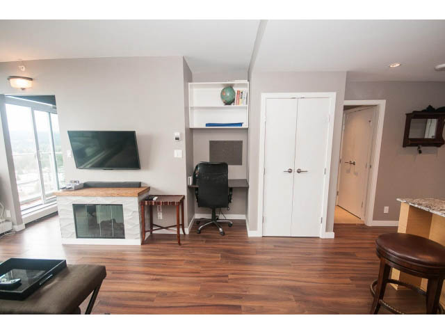 Open-concept living space with hardwood floors, a city view, and a modern kitchen island. - 1702 - 135 East 17th Street, North Vancouver