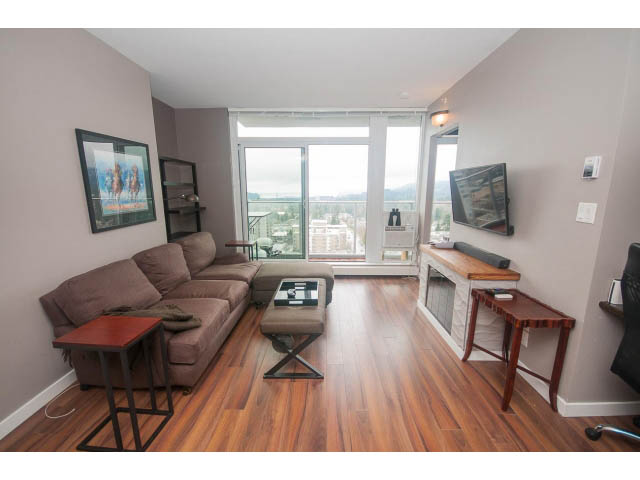 Furnished 1-bedroom condo with hardwood floors, city view, and modern decor. - 1702 - 135 East 17th Street, North Vancouver