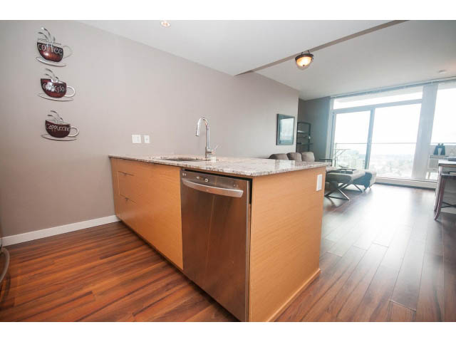Bright kitchen with wooden countertops, hardwood floors, and a city view. - 1702 - 135 East 17th Street, North Vancouver