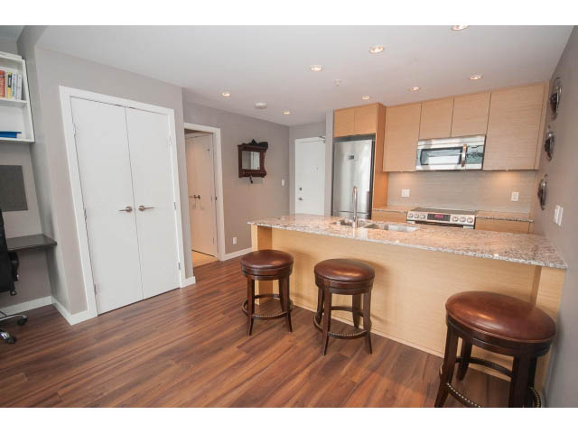 Bright kitchen with granite countertops, hardwood floors, and a modern design. - 1702 - 135 East 17th Street, North Vancouver