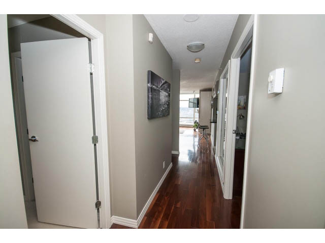 Furnished hallway with hardwood floors and a city view. - 2706 -198 Aquarius Mews, Vancouver Downtown