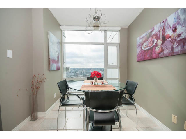Furnished dining area with city view and modern decor. - 2706 -198 Aquarius Mews, Vancouver Downtown