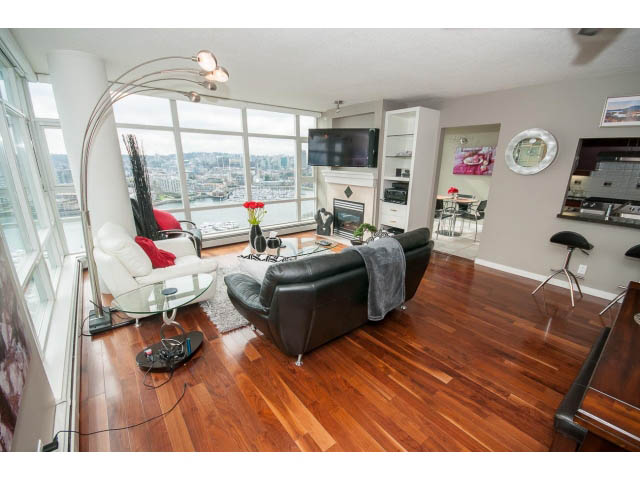 Spacious living room with hardwood floors, city view, and modern furnishings. - 2706 -198 Aquarius Mews, Vancouver Downtown