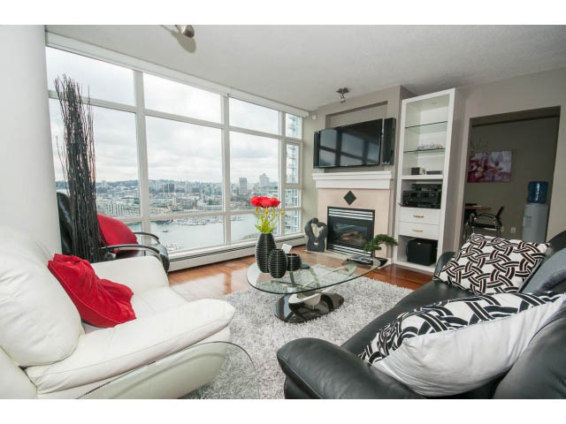 Bright living room with city view, modern furniture, and large windows. - 2706 -198 Aquarius Mews, Vancouver Downtown