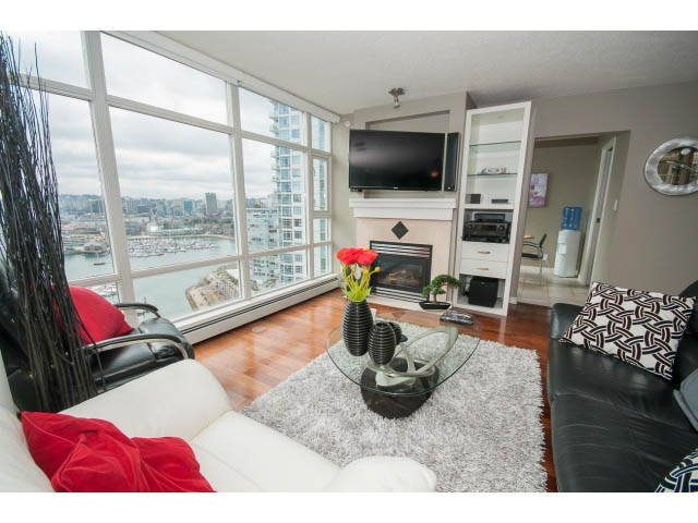Furnished living room with hardwood floors, city view, and modern decor. - 2706 -198 Aquarius Mews, Vancouver Downtown