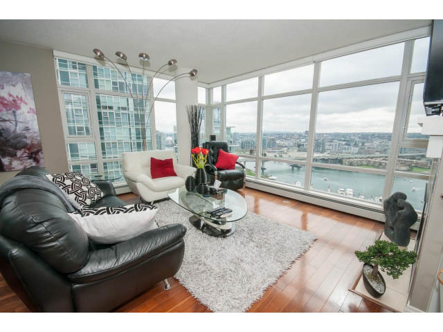 Spacious living room with hardwood floors, city view, and modern furnishings. - 2706 -198 Aquarius Mews, Vancouver Downtown