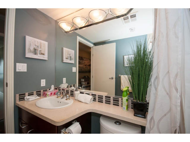 Furnished bathroom with modern sink, countertop, and large mirror. - 2706 -198 Aquarius Mews, Vancouver Downtown