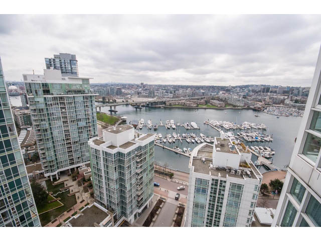 Bright living room with city view and modern furnishings. - 2706 -198 Aquarius Mews, Vancouver Downtown