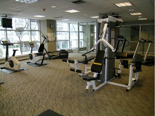 Fitness room with cardio machines and weight equipment, large windows offering city views. - 2706 -198 Aquarius Mews, Vancouver Downtown