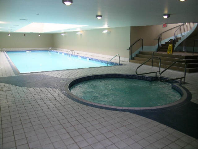 Spacious indoor pool area with tiled floors and stairs leading up. - 2706 -198 Aquarius Mews, Vancouver Downtown