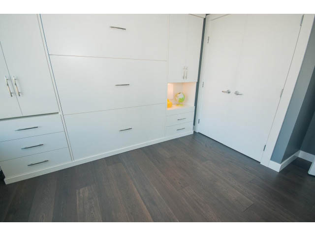 Bright and modern bedroom with white cabinetry and dark hardwood floors. - 1203 - 1188 Richards, Vancouver Downtown
