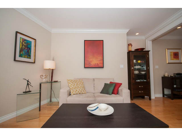 Furnished living room with hardwood floors, modern decor, and a glass coffee table. - 3 - 2535 West 6th Ave, Vancouver West Side