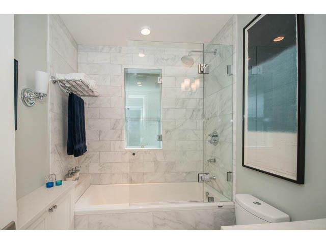 Furnished bathroom with marble tiles, walk-in shower, and modern fixtures. - 3 - 2535 West 6th Ave, Vancouver West Side