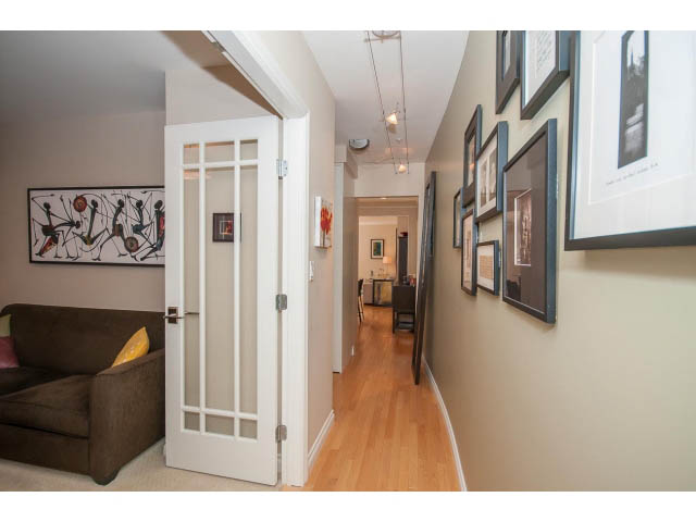 Furnished hallway with hardwood floors and artwork on walls. - 3 - 2535 West 6th Ave, Vancouver West Side