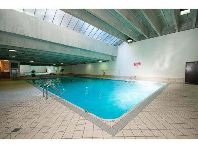 Spacious, modern indoor pool area with tiled flooring and skylights. - 606 - 2020 Fullerton Ave, North Vancouver