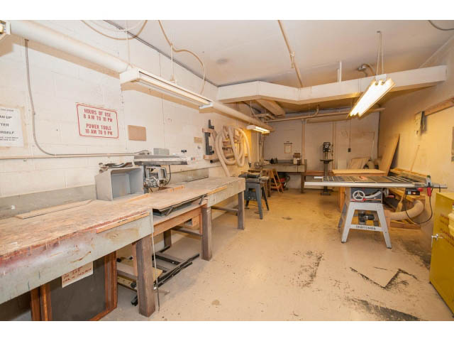 Workshop with wooden tables and power tools, clean and organized. - 606 - 2020 Fullerton Ave, North Vancouver