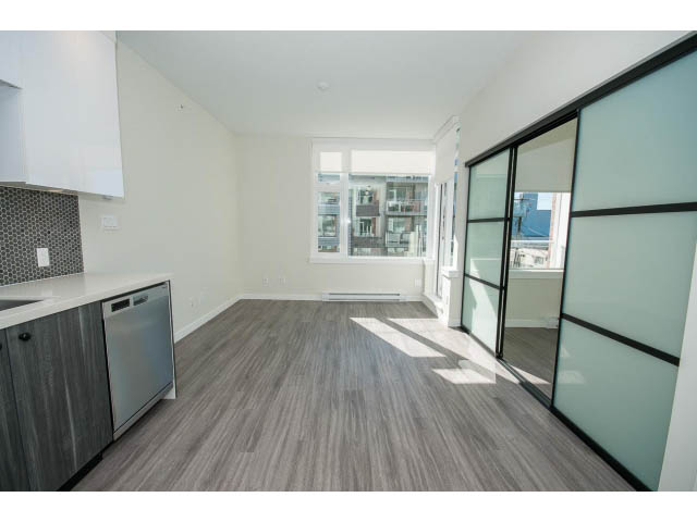 Bright kitchen with granite countertops, hardwood floors, and a city view. - 317 - 311 East 6th Avenue, Vancouver East Side