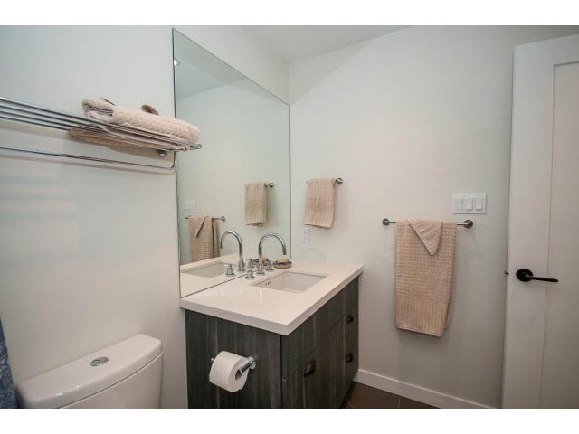 Bright bathroom with white countertops and a large mirror. - 317 - 311 East 6th Avenue, Vancouver East Side