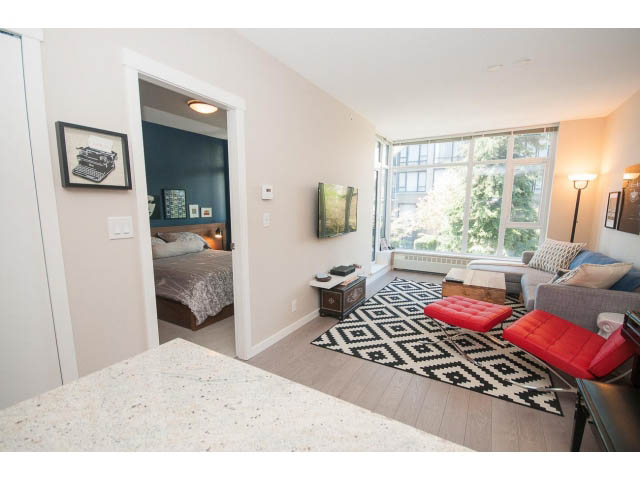 Bright kitchen with granite countertops, hardwood floors, and a city view. - 203 - 135 West 2nd Street, North Vancouver