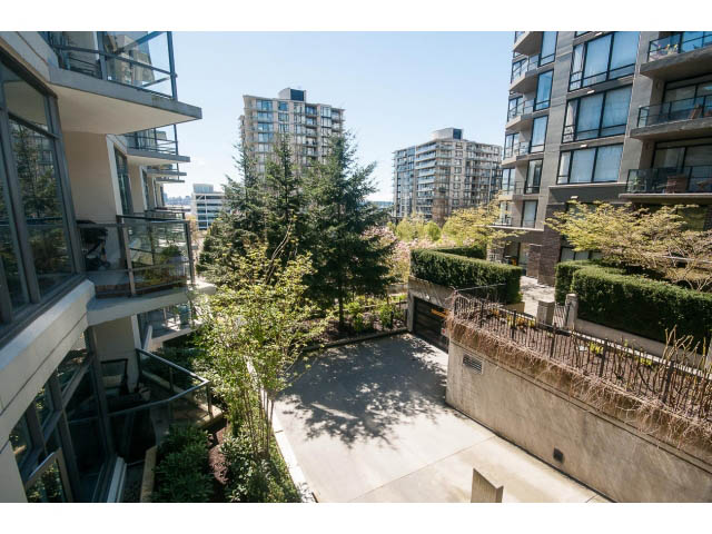 Bright living room with city view and modern furnishings. - 203 - 135 West 2nd Street, North Vancouver