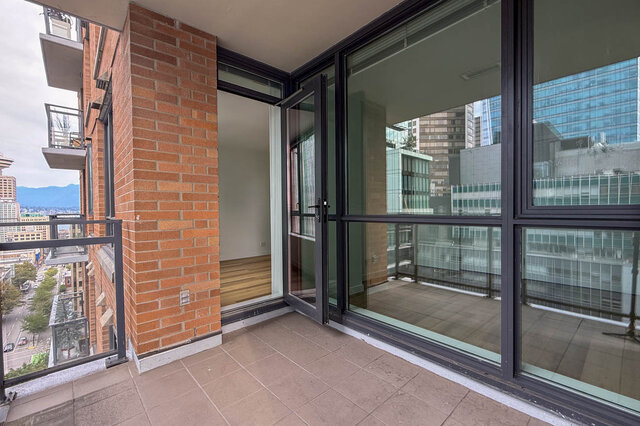 Balcony with floor-to-ceiling glass windows and a sweeping downtown city view. - 1904-788 Richards Street, Vancouver Downtown