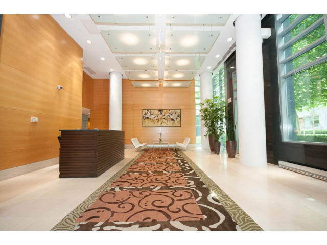Furnished living room with modern decor, large windows, and a patterned rug. - 502 - 590 Nicola Street, Vancouver Downtown
