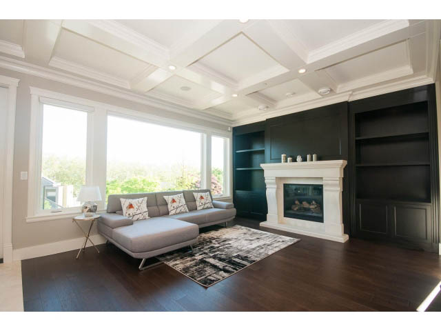 Spacious living room with coffered ceiling, dark hardwood floors, and built-in entertainment center. - 3921 West 10th, Vancouver West Side