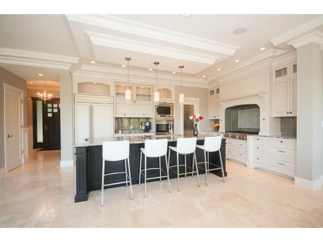 Bright kitchen with white cabinetry, granite countertops, and pendant lighting. - 3921 West 10th, Vancouver West Side