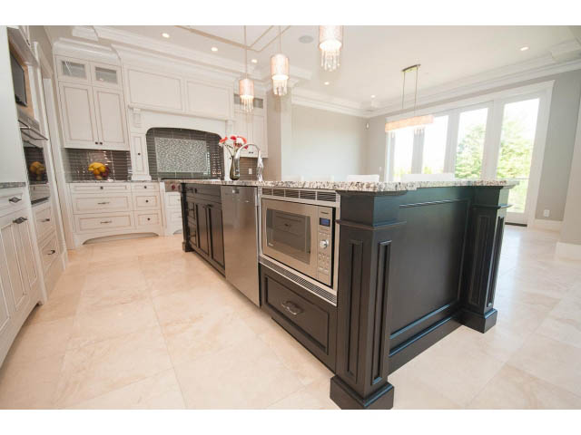 Bright kitchen with granite countertops and marble flooring, featuring a large island and modern appliances. - 3921 West 10th, Vancouver West Side