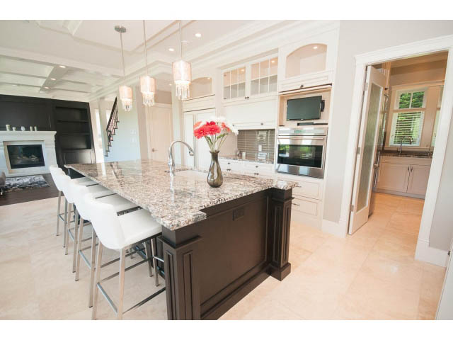 Bright kitchen with granite countertops, hardwood floors, and a view of the living area. - 3921 West 10th, Vancouver West Side