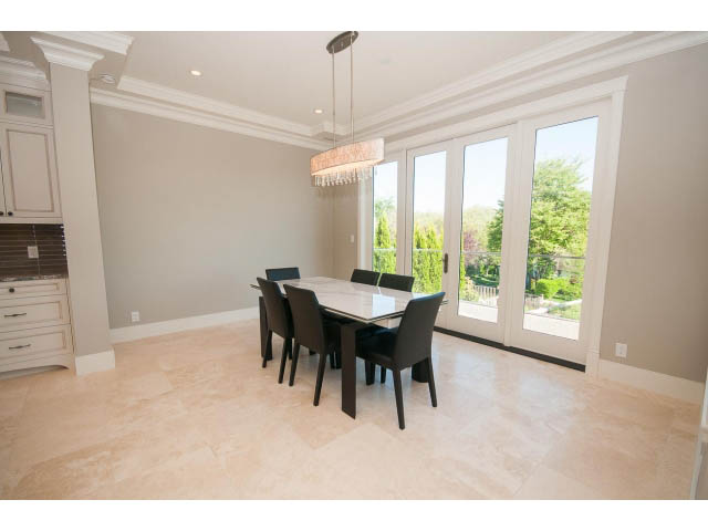 Bright dining area with marble countertops and large windows, showcasing a city view. - 3921 West 10th, Vancouver West Side