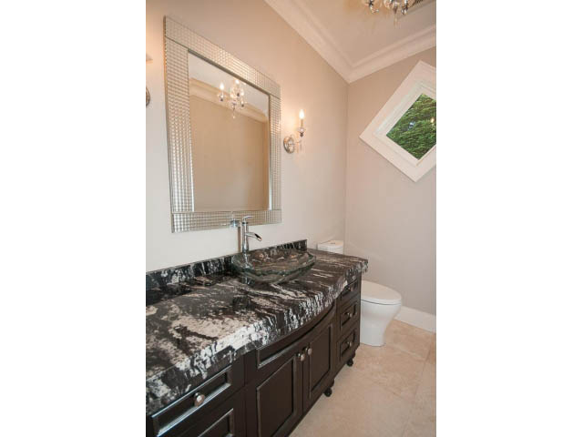 Furnished bathroom with dark marble countertops and a large mirror. - 3921 West 10th, Vancouver West Side