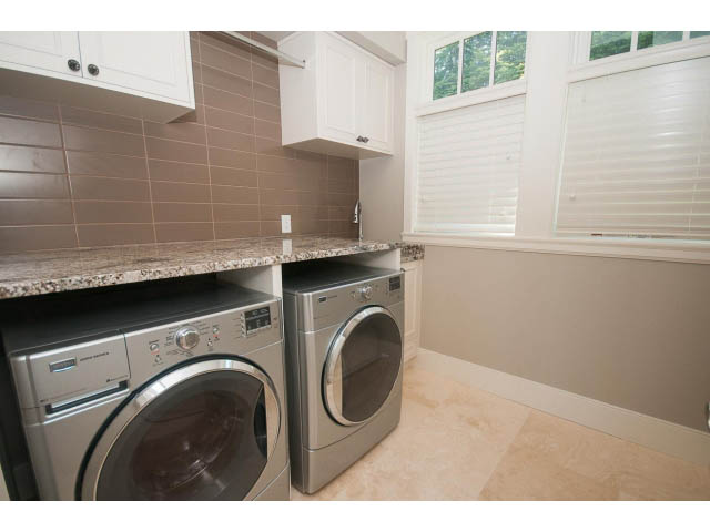 Bright laundry room with granite countertops and a window. - 3921 West 10th, Vancouver West Side
