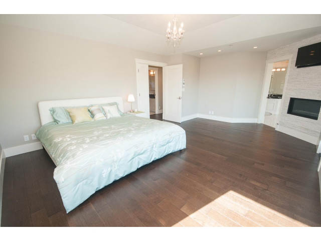 Furnished master bedroom with hardwood floors and a chandelier. - 3921 West 10th, Vancouver West Side